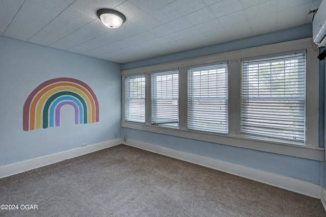 carpeted spare room featuring a healthy amount of sunlight