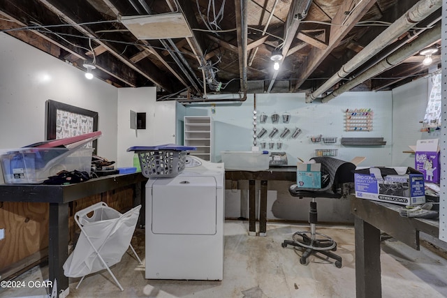 office area with washer / clothes dryer, concrete flooring, and a workshop area