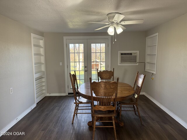 dining space featuring a wall mounted air conditioner, french doors, dark hardwood / wood-style flooring, a textured ceiling, and ceiling fan