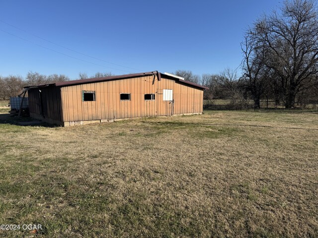 view of outbuilding with a yard