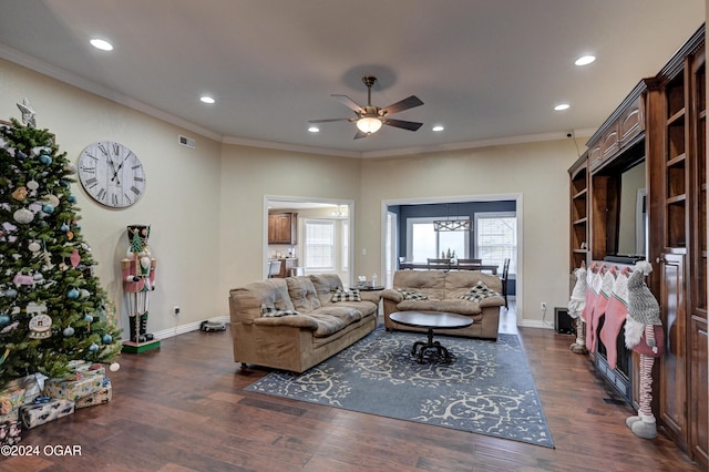 living room featuring dark hardwood / wood-style floors, ceiling fan, and ornamental molding