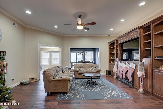 living room with crown molding, ceiling fan, and dark wood-type flooring