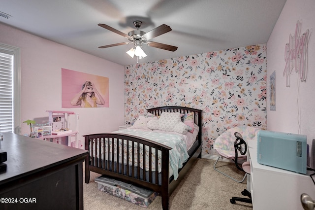 bedroom featuring ceiling fan and light carpet