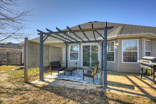 back of property with a pergola and a patio area