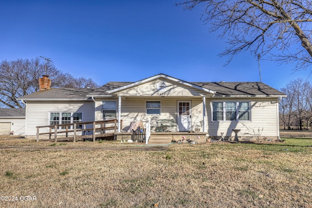 view of front of home with a front yard and a deck