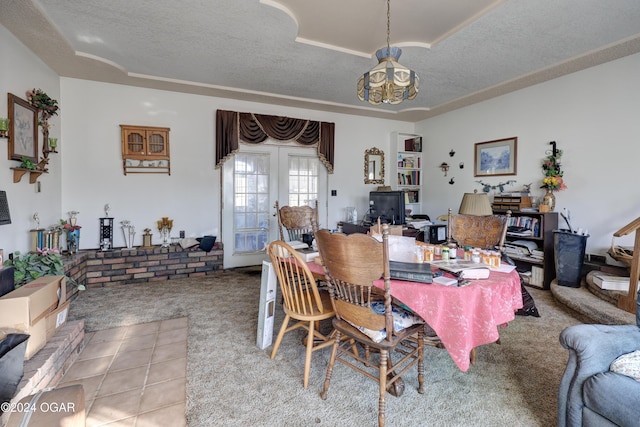 dining area featuring a textured ceiling, a notable chandelier, light carpet, and french doors