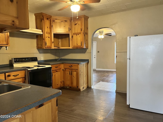 kitchen featuring dark hardwood / wood-style flooring, white appliances, crown molding, and sink