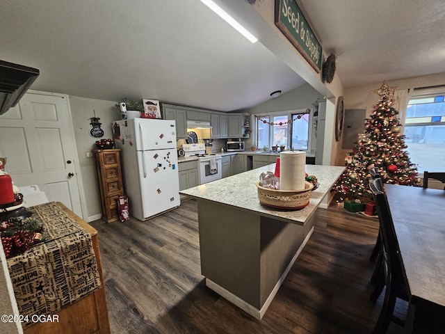 kitchen with vaulted ceiling, dark wood-type flooring, a healthy amount of sunlight, and white appliances