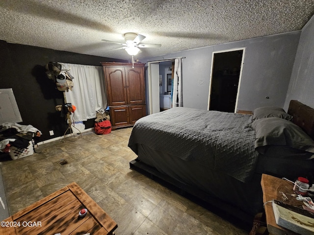 bedroom featuring ceiling fan, a spacious closet, a textured ceiling, and a closet