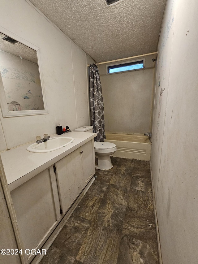 full bathroom with vanity, shower / tub combo, a textured ceiling, and toilet