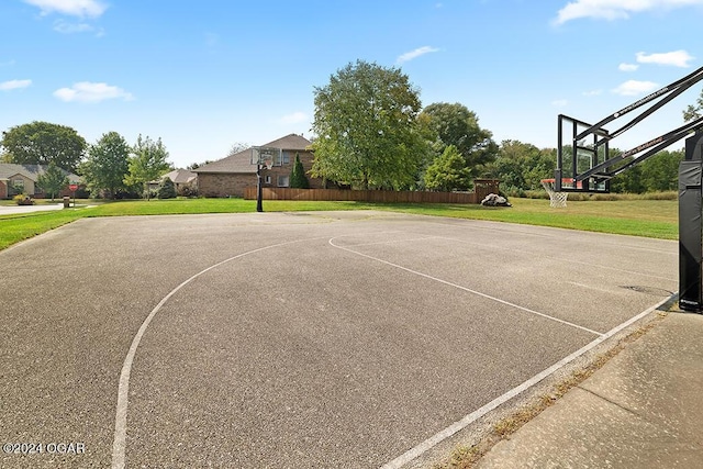 view of basketball court with a yard