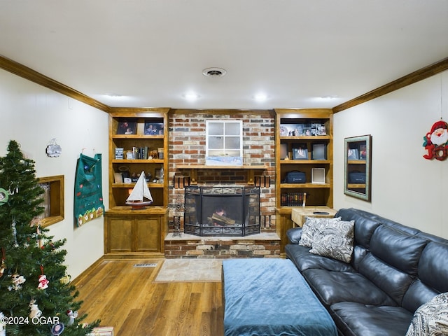 living room featuring a fireplace, wood-type flooring, and ornamental molding