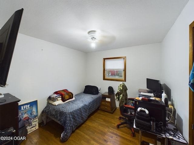 bedroom featuring ceiling fan and dark hardwood / wood-style flooring