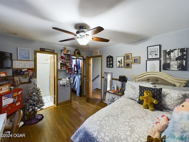 bedroom with ceiling fan and dark hardwood / wood-style flooring