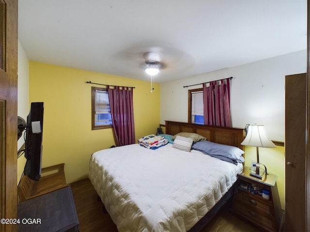 bedroom with ceiling fan and dark wood-type flooring