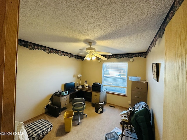 office with carpet flooring, ceiling fan, and a textured ceiling