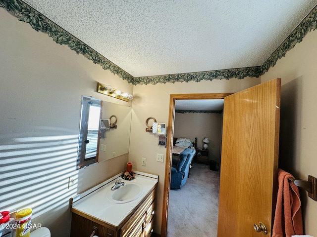 bathroom with vanity and a textured ceiling