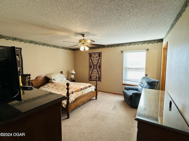 bedroom featuring ceiling fan, light carpet, and a textured ceiling