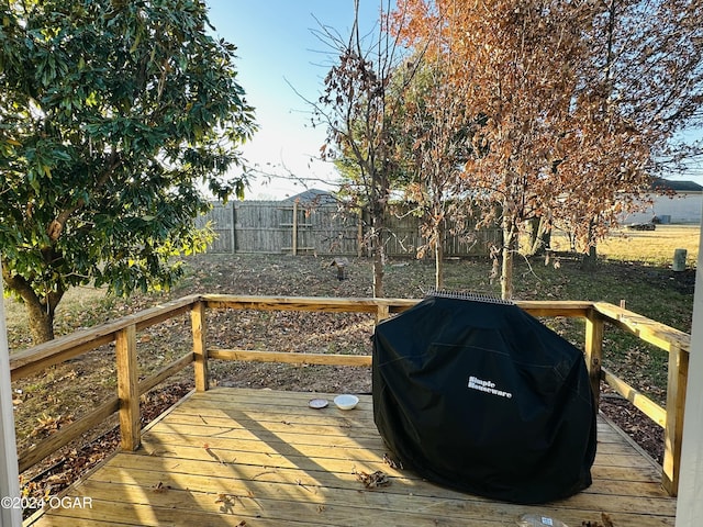 wooden deck featuring a grill