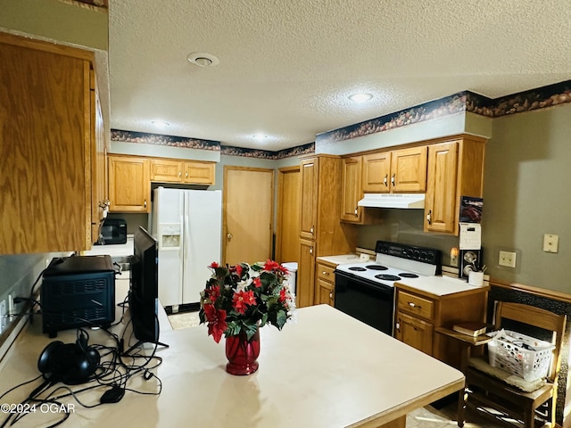 kitchen with a textured ceiling and white appliances