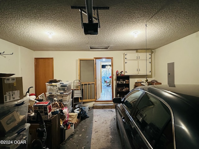 garage featuring electric panel and a garage door opener