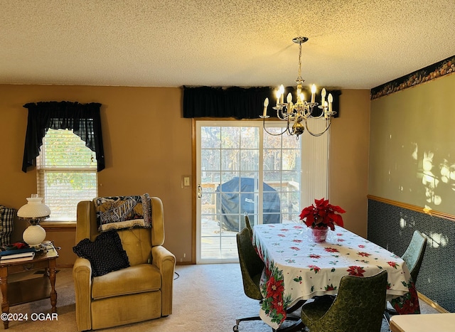 carpeted dining space with a textured ceiling and a notable chandelier