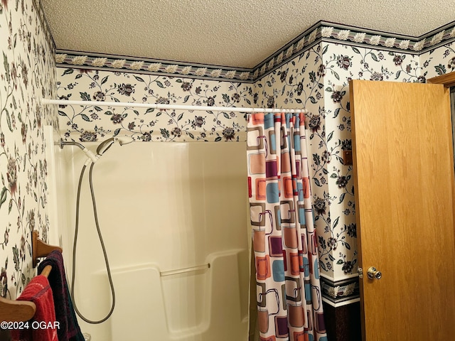 bathroom with a textured ceiling and walk in shower