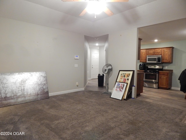 living room with ceiling fan and dark carpet