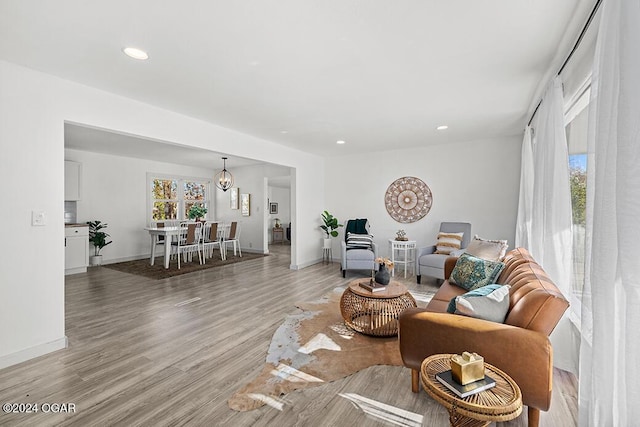 living room featuring hardwood / wood-style flooring and an inviting chandelier