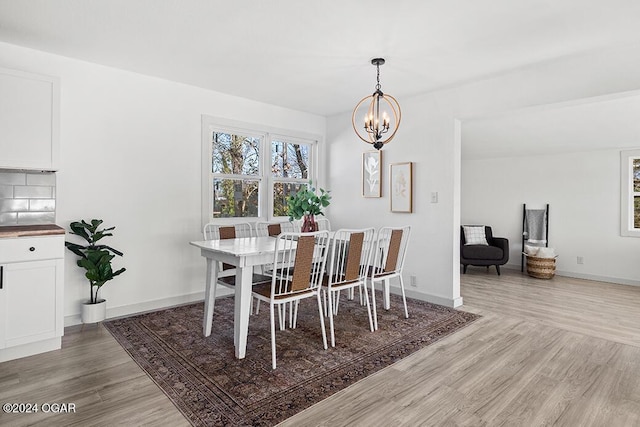 dining room featuring a notable chandelier and wood-type flooring