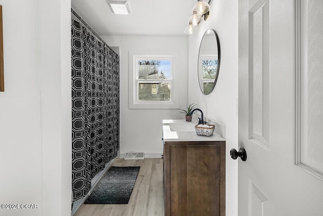 bathroom with vanity, curtained shower, and wood-type flooring