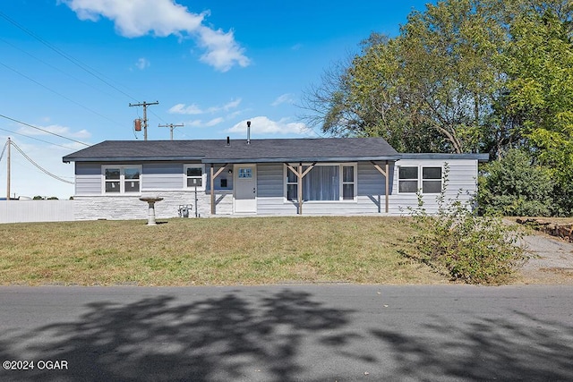 ranch-style home with a front lawn