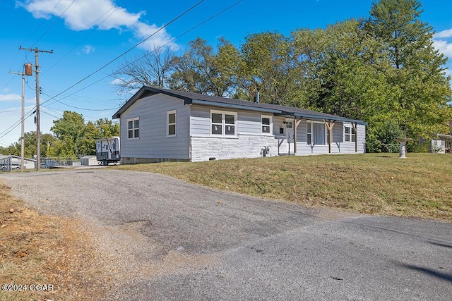 view of front of house with covered porch and a front yard