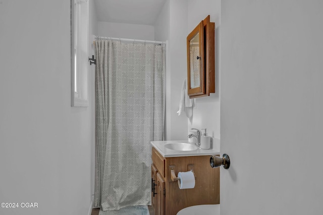 bathroom featuring curtained shower and vanity