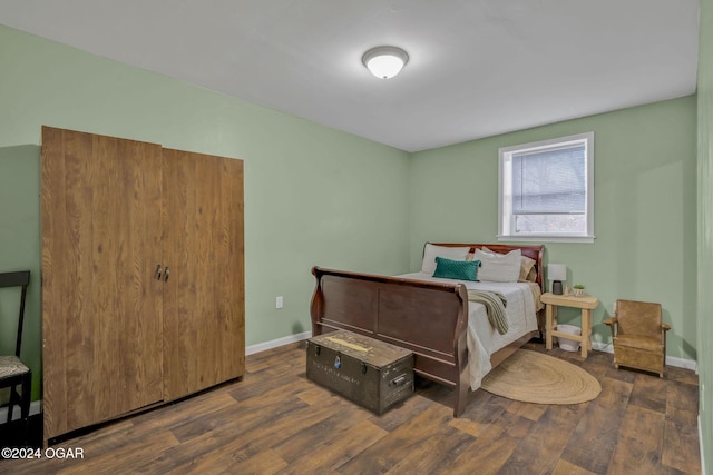 bedroom with dark hardwood / wood-style floors