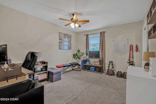 carpeted office space with ceiling fan