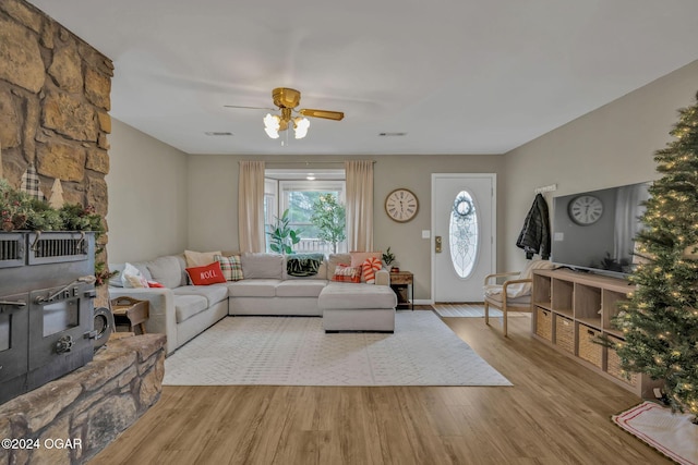 living room featuring ceiling fan and light hardwood / wood-style floors