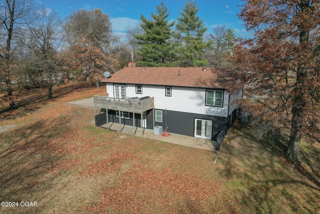 back of house featuring a patio area, a yard, and a wooden deck