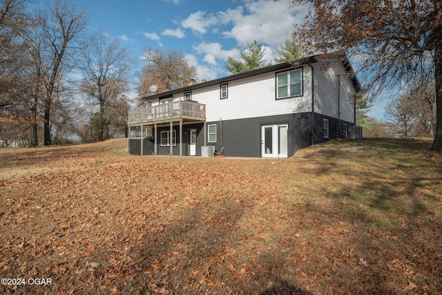 back of house with a lawn, cooling unit, a deck, and french doors