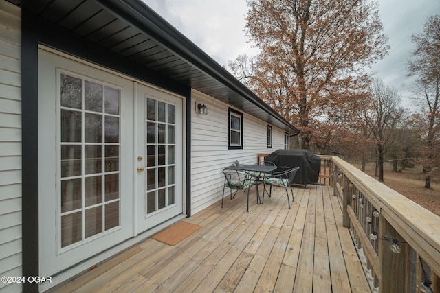 wooden terrace featuring grilling area and french doors