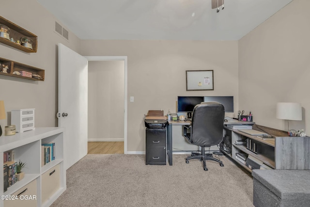 office area with light carpet and ceiling fan