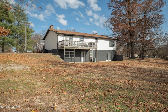 back of house with a deck