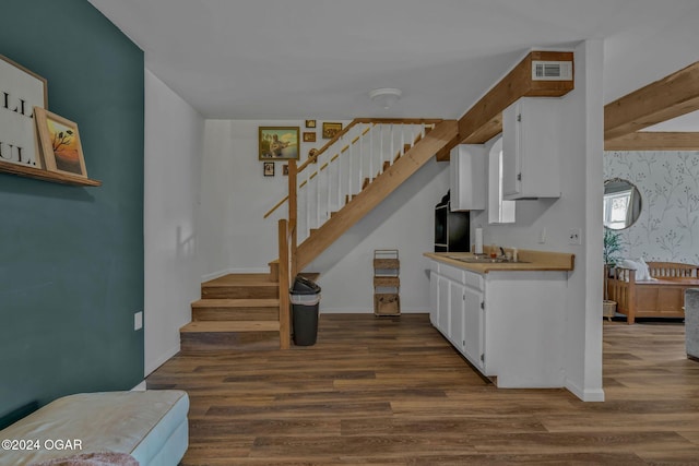 kitchen featuring white cabinetry, sink, and dark wood-type flooring