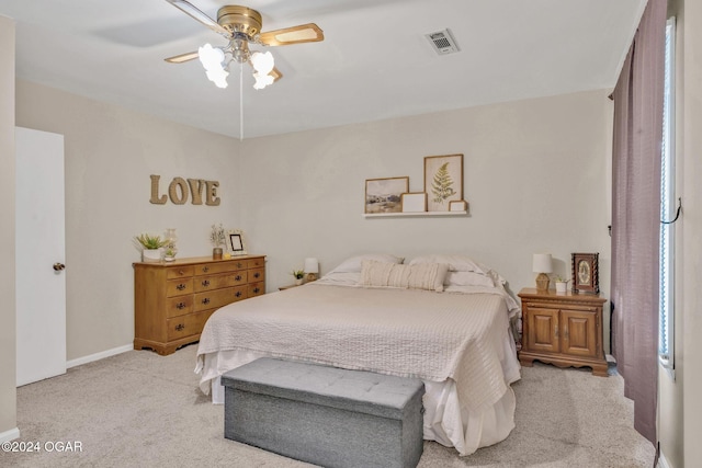 carpeted bedroom with multiple windows and ceiling fan