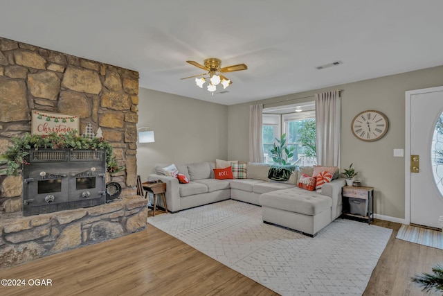 living room featuring ceiling fan and wood-type flooring