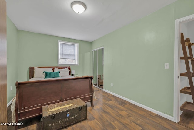 bedroom with dark hardwood / wood-style floors