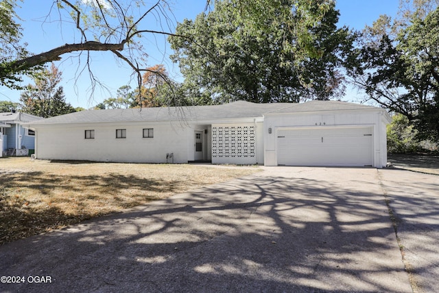 ranch-style house featuring a garage