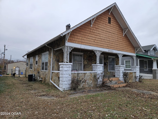 view of front of house with covered porch and central AC unit