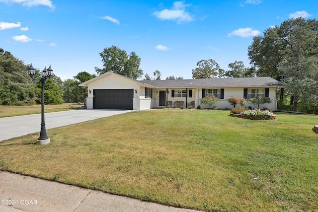 single story home with a garage and a front lawn