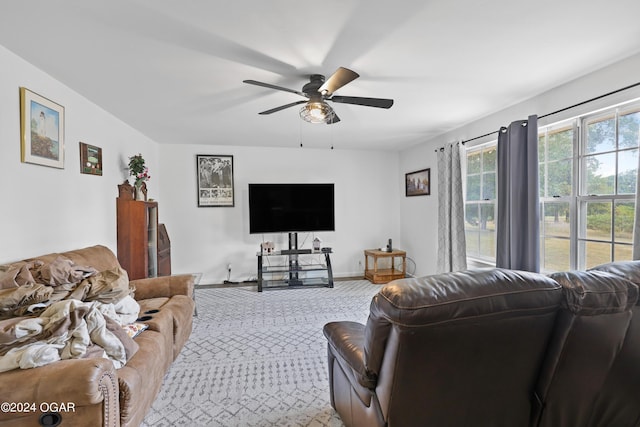 carpeted living room with ceiling fan